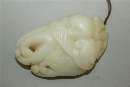 A Chinese white jade carving of a boy clambering on a finger citron, 7.7cm